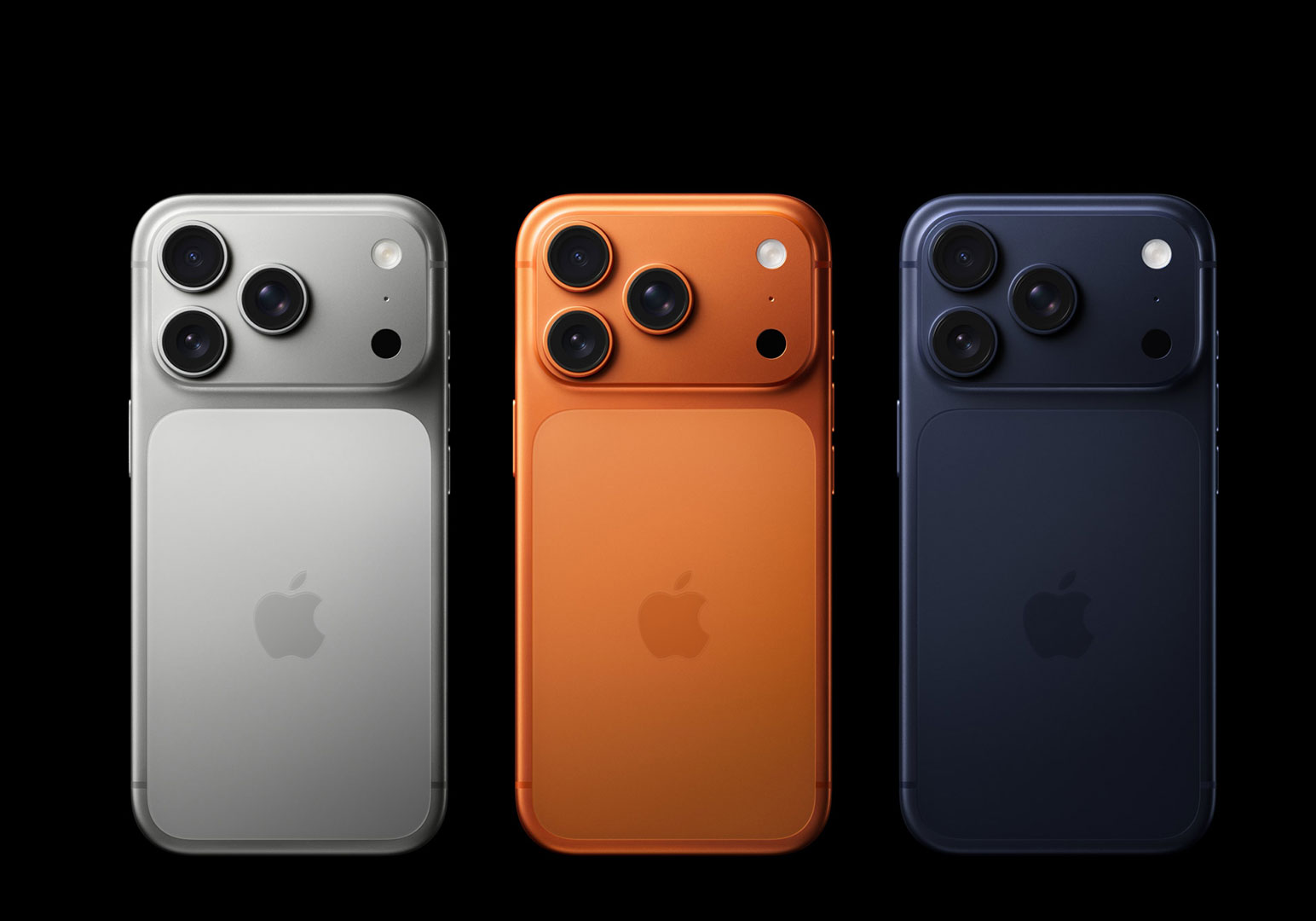 Three smartphones in silver, orange, dark blue.