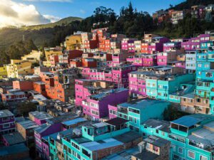 Colorful houses densely packed on a hillside under a sunny sky.