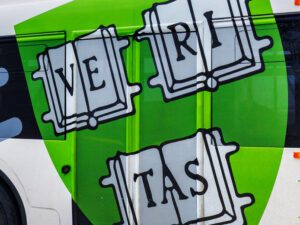 Green Veritas book graphic on bus